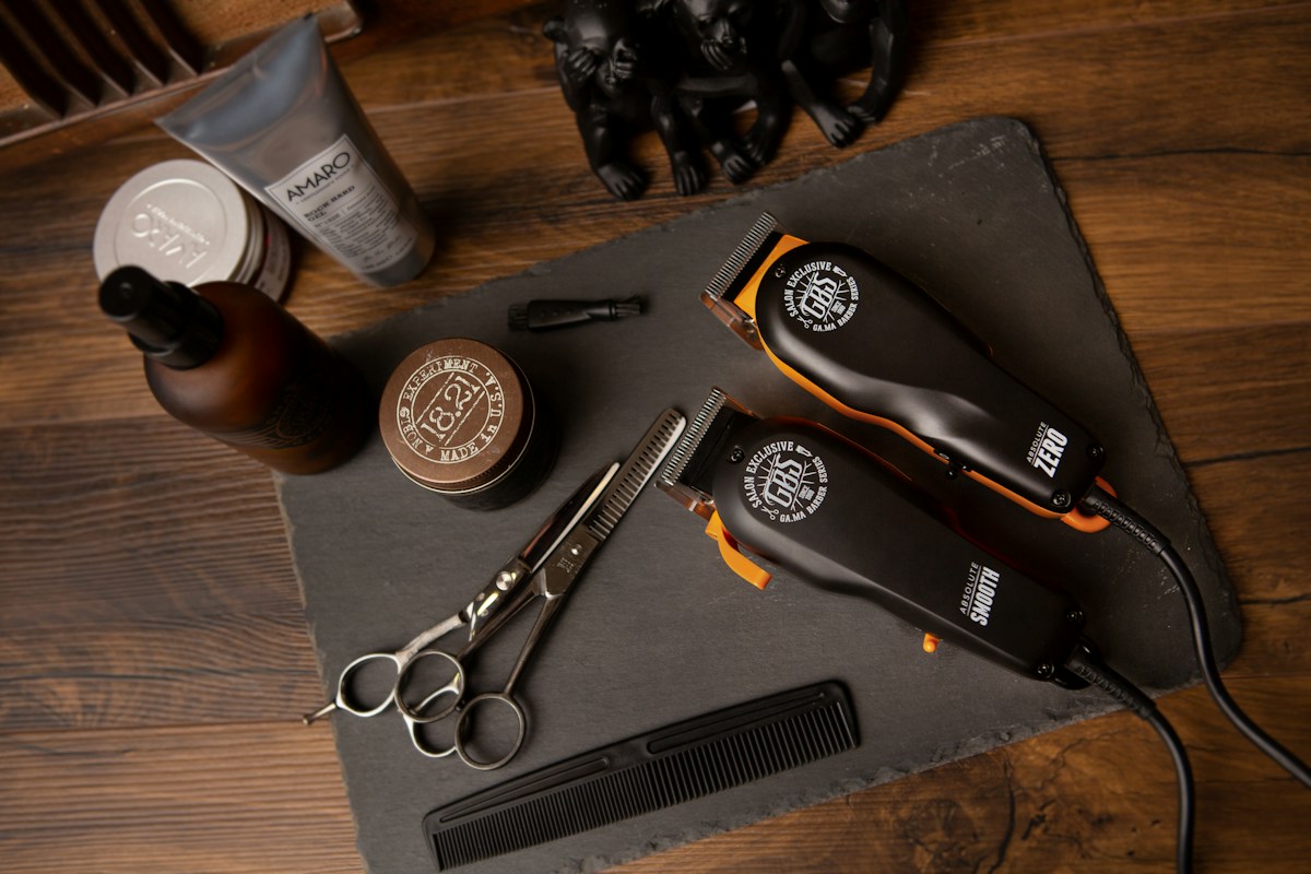 A barber carefully shaping a client's haircut