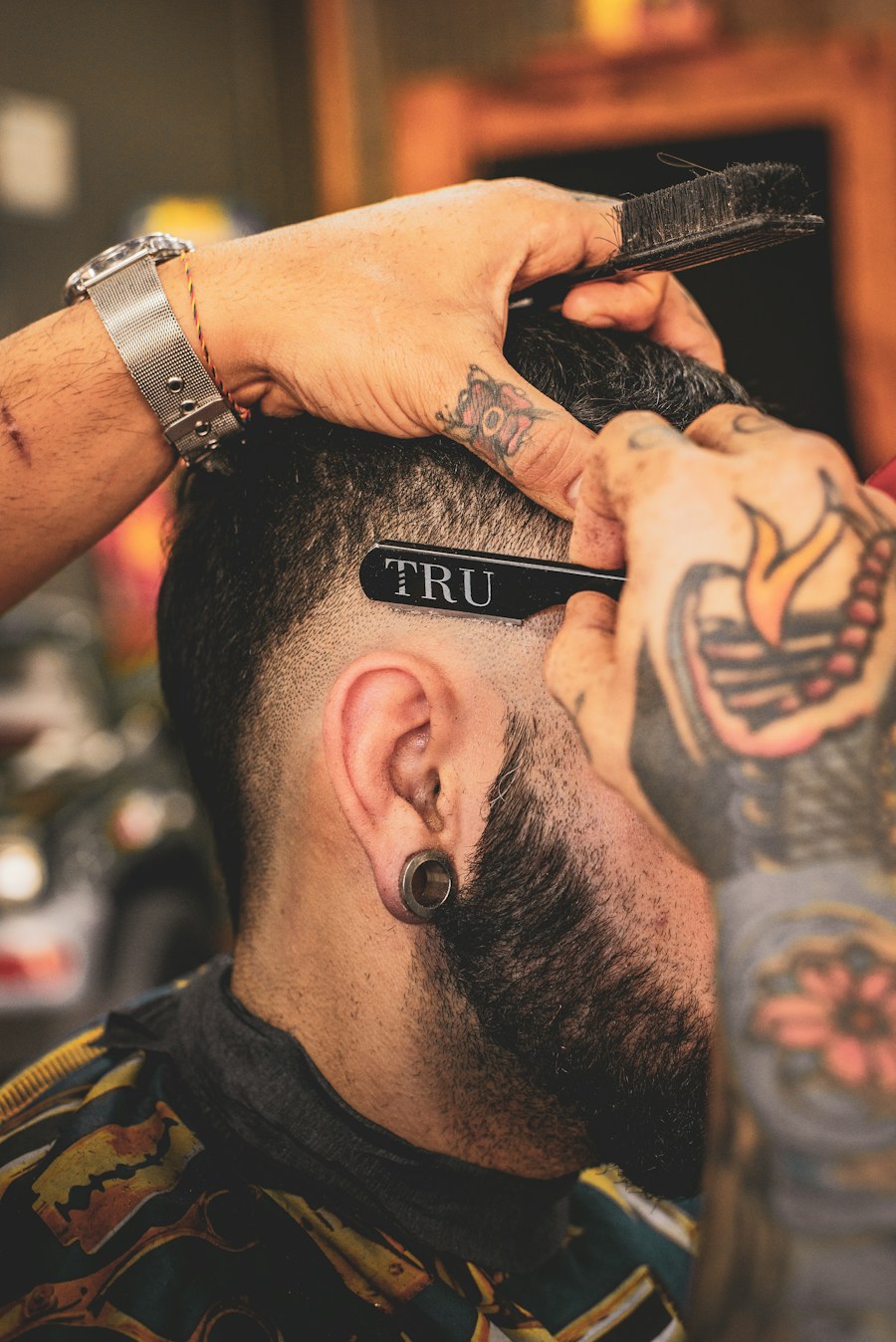 Barber working on a detailed fade haircut